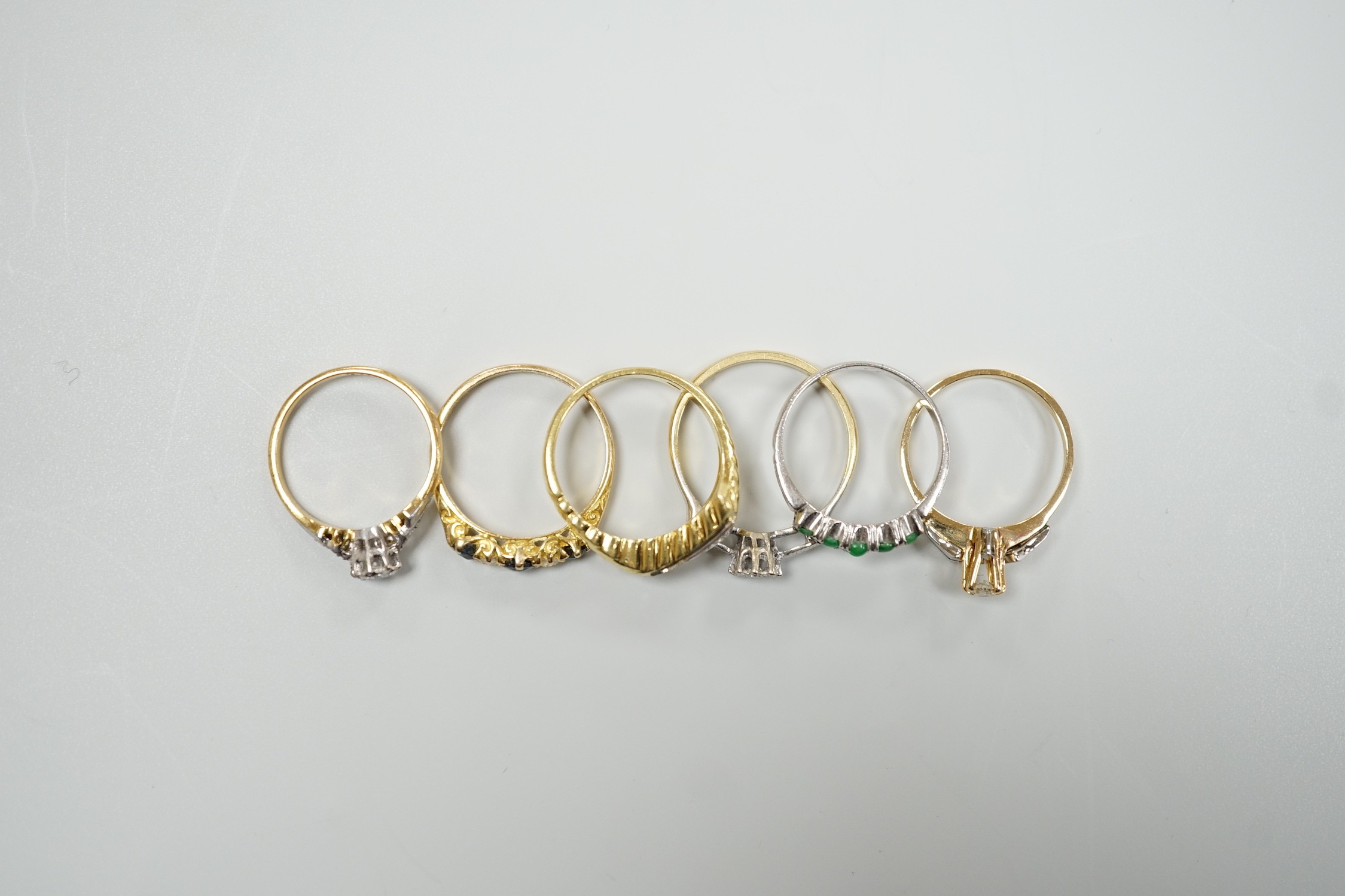 Six assorted mainly modern 18ct and gem set rings, including single stone diamond and George V sapphire and diamond set half hoop ring, size N, gross weight 15.9 grams.